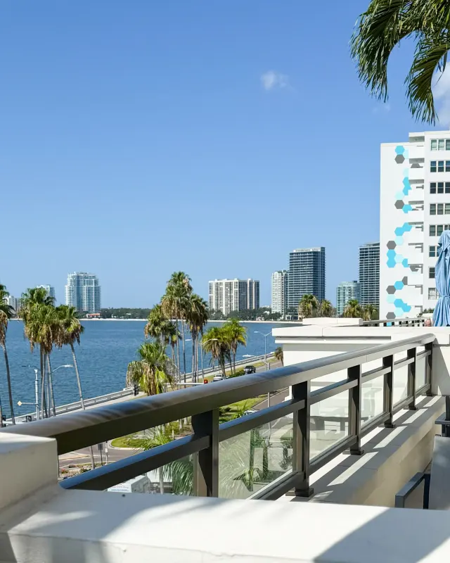 Glass balcony railing with views of Bayshore Boulevard, Tampa.