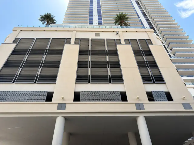 Art House podium façade with perforated screen bands.