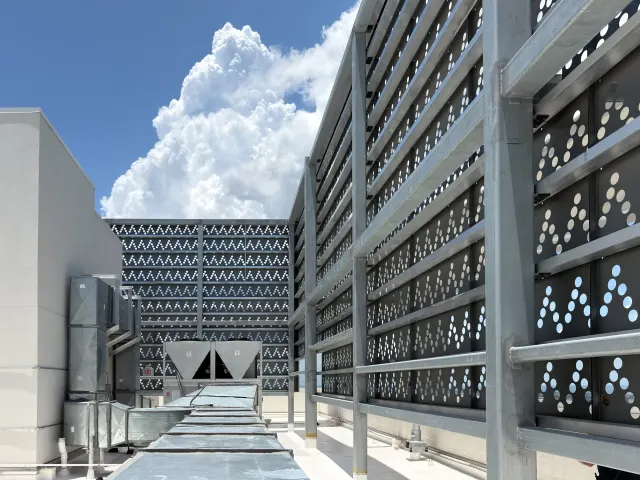 Perforated rooftop mechanical screens at Art House.