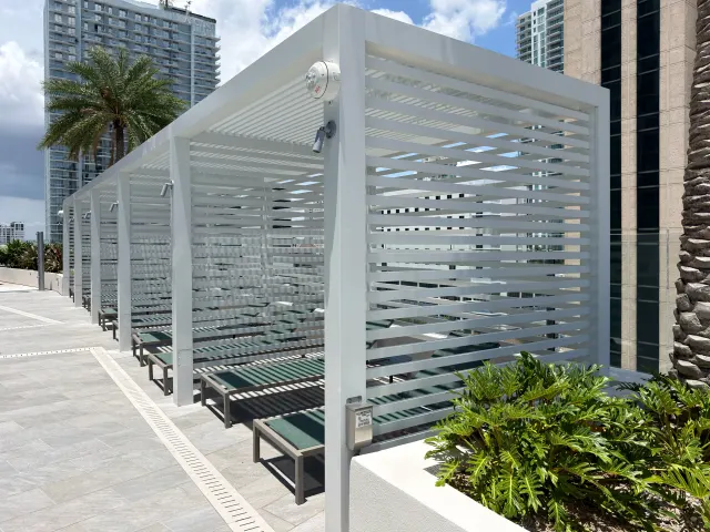 Louvered pergola with slatted privacy walls at the Art House pool.
