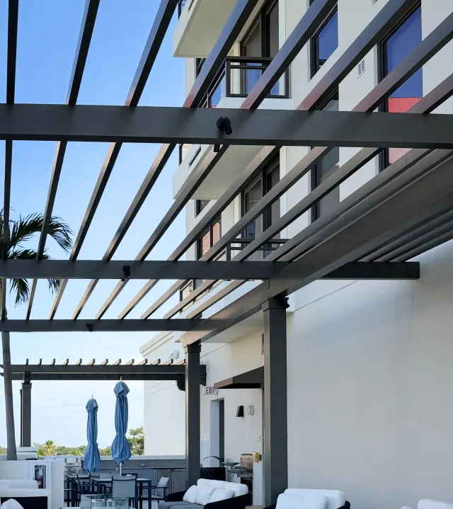 Pergolas shading the Hyde Park House rooftop terrace.