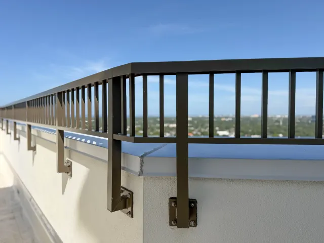 Picket guardrail on custom brackets along the Hyde Park House roofline.